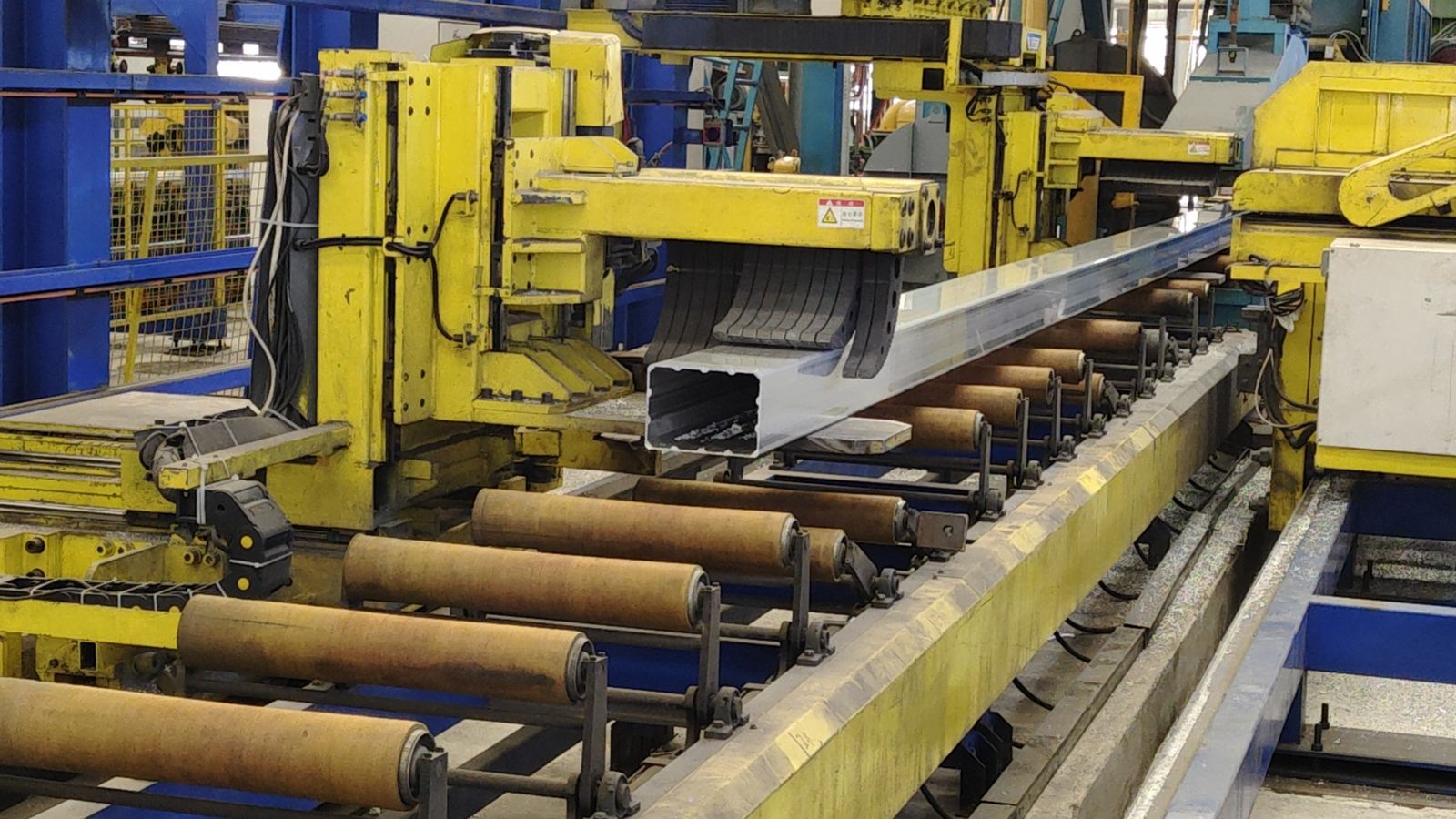 Aluminum profile emerging from extrusion press die